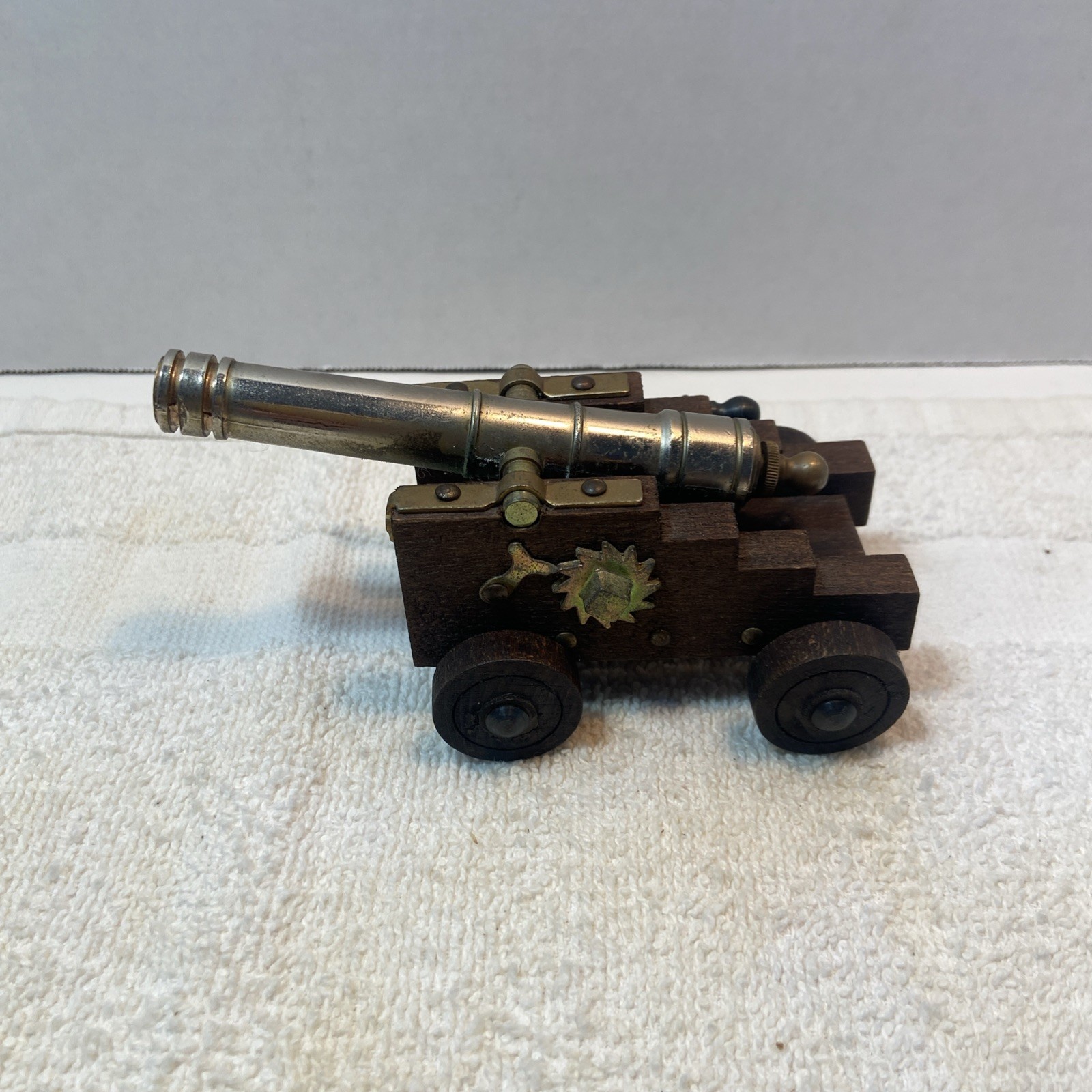 Vintage Miniature Cannon With Silver Metal Barrel On Dark Wood Carriage Wheels
